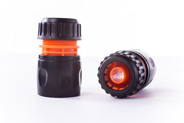 Adapter for connection of a garden hose with watering system