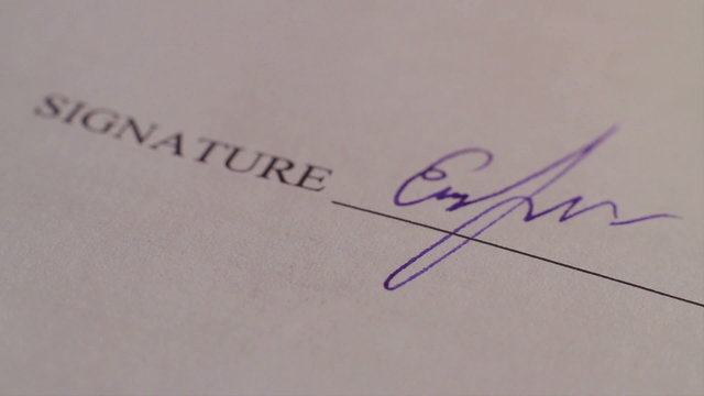 Close-up person putting signature, signing contract, macro