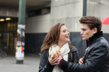 Couple In Jackets Holding Hot Dog
