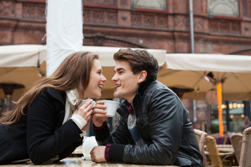 Couple Sharing Biscuit At Outdoor Restaurant