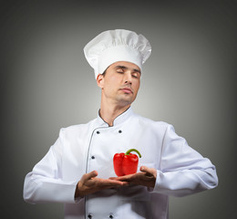 Humorous portrait of a chef with a red pepper heart