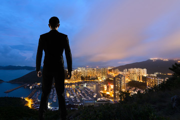 Asian businessman standing in the hill