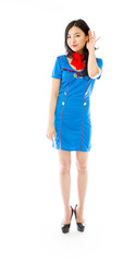 Asian air stewardess with hand to ear listening isolated over