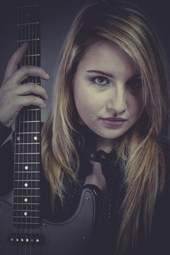 Sound, Beautiful blond girl with black electric guitar