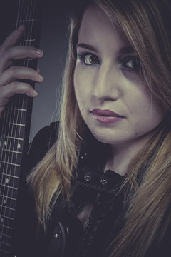 Rock, Beautiful blond girl with black electric guitar