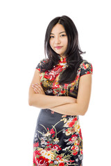 Confident Asian young woman standing with arms crossed