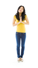 Fototapeta premium Young Asian woman standing in prayer position