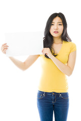 Obraz na płótnie Canvas Sad Asian young woman holding a blank placard