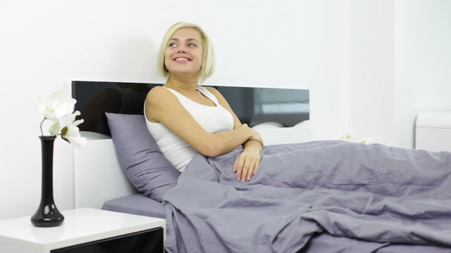 woman lying in bed smile