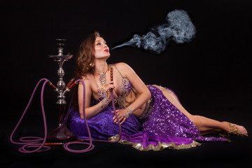 Belly dancer smoking hookah