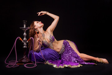 Belly dancer posing with hookah