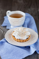 Tartlet with cream and cup of tea