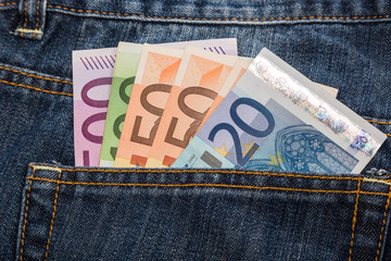 Euro banknotes in jeans back pocket