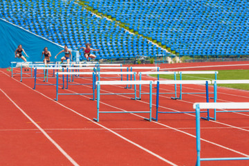 athletes race with obstacles