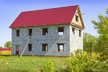 House from foam concrete blocks in the meadow