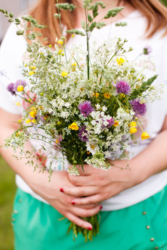 Woman holding wild flowers