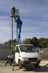 Worker in truck mounted basket crane platform