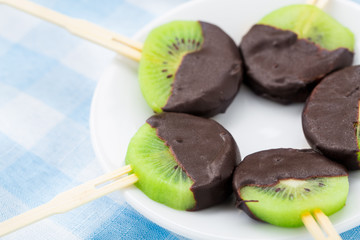 Kiwi with chocolate on a stick