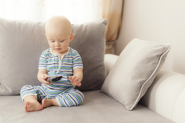 baby uses a remote control for tv