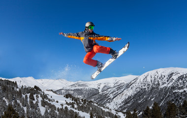 Naklejka na ściany i meble Snowboarder jumping high like ninja
