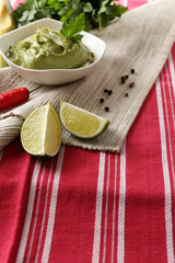 Fresh guacamole in bowl on table