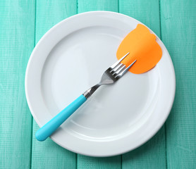 Empty note paper attached to fork,