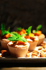 Tasty pumpkin muffins on wooden table