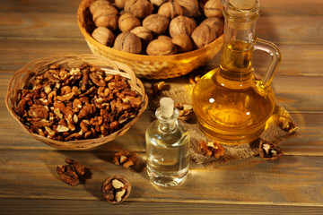 Walnut oil and nuts on wooden table