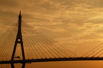 Fototapeta na wymiar Black silhouette of suspended bridge during sunrise