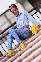 Stock photo Woman sitting and smiling on a staircase