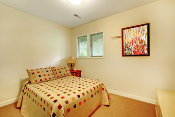 Small bedroom with colorful bed