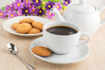Coffee cup and cookies on table