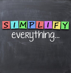 Fototapeta na wymiar Simplify things and everything concept text on blackboard with a