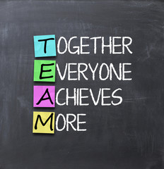 Teamwork concept with adehsive notes on blackboard