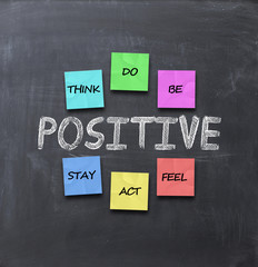 stay positive advice with adhesive notes on blackboard