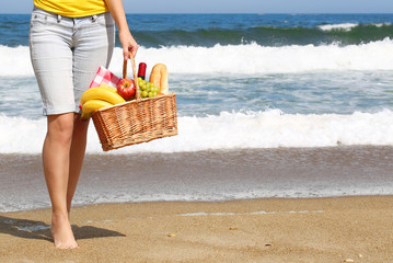 Picnic on the Beach. Female Legs and Basket
