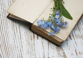 Forget-me-nots flowers and old book