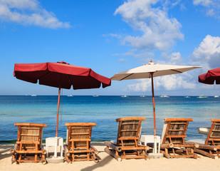 Beach chairs on tropical white sand beach