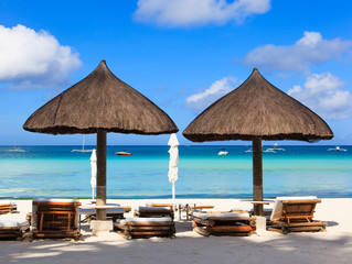 Beach chairs on tropical white sand beach