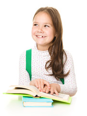 Cute girl is reading book