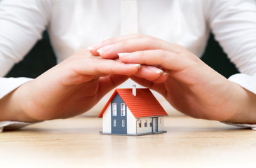 house covered of woman hands - insurance real estate concept - obrazy, fototapety, plakaty