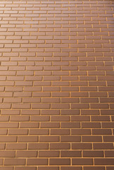 Modern brick wall in a bright sunny day as background. Look from