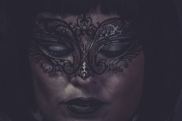 Sad, portrait of woman with black mask thread Venetian