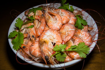 Bowl of cooked prawns decorated by parsley