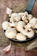 Fresh button mushrooms in skillet