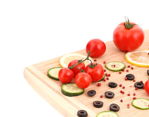 Composition of vegetables on wooden platter.