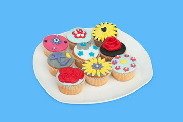 A plate with colorful cup-cakes