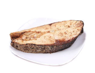 Fish steak on the round plate.
