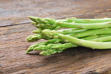 Bunch of fresh green asparagus spears on a rustic wooden table