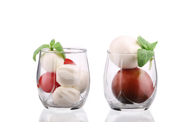Tomatoes and mozzarella balls in glass.